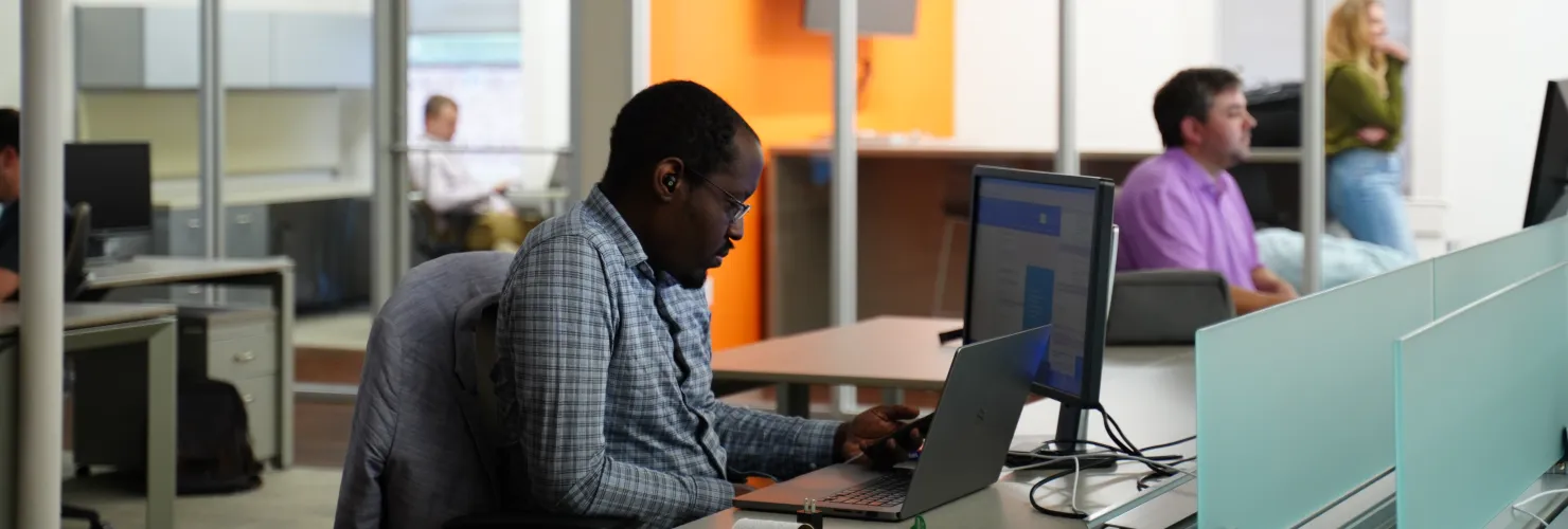 Cyberwoven web developer sitting at his desk working on a client project.